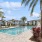 a pool with palm trees and buildings
