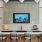 a room with a tv and chairs