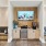 a room with a tv and chairs