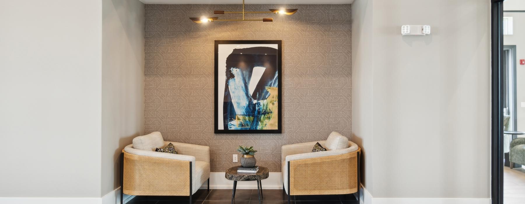 a room with a couch and a painting on the wall