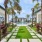 a swimming pool with palm trees and a building
